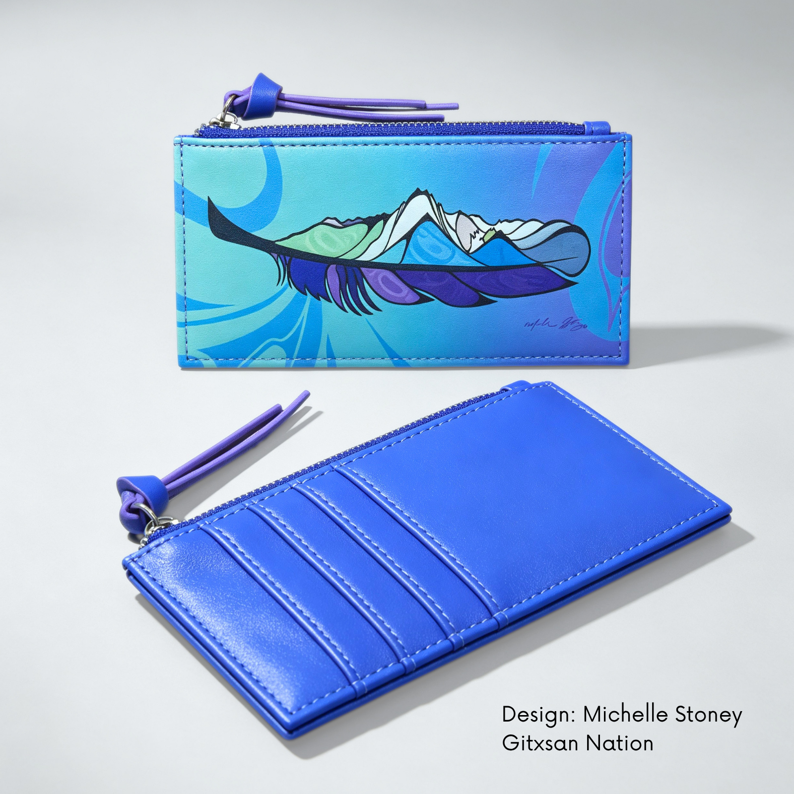 A blue leather zip pouch shown in two views on a light gray background: one closed with Michelle Stoney’s colourful Healing Feather artwork,  on the front, and one open showing card slots and a purple zipper pull. Text at bottom right reads 'Design: Michelle Stoney Gitxsan Nation'.

synthetic leather card holder 