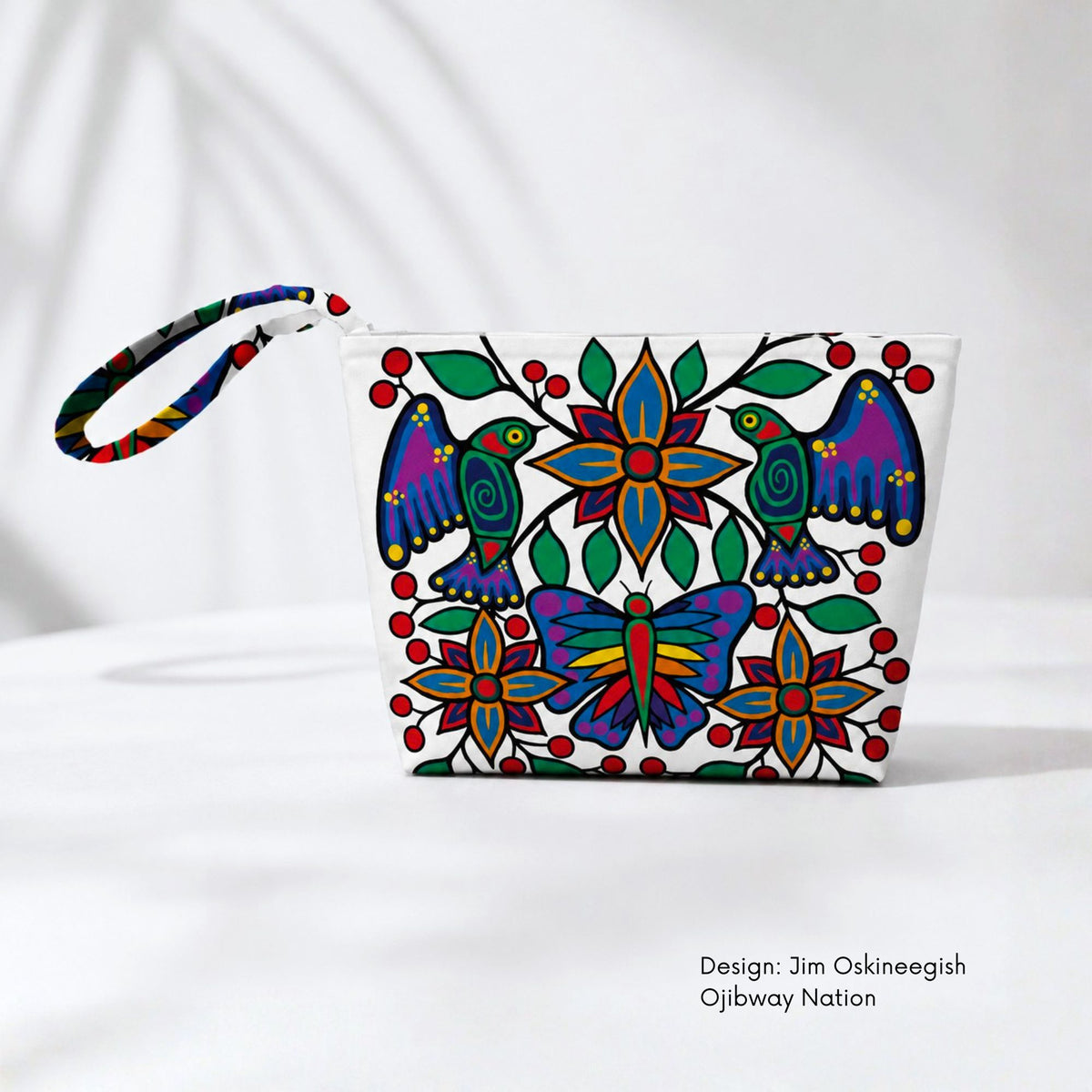 White canvas pouch featuring two colourful birds, a butterfly, blue and orange flowers, green leaves and red berries.