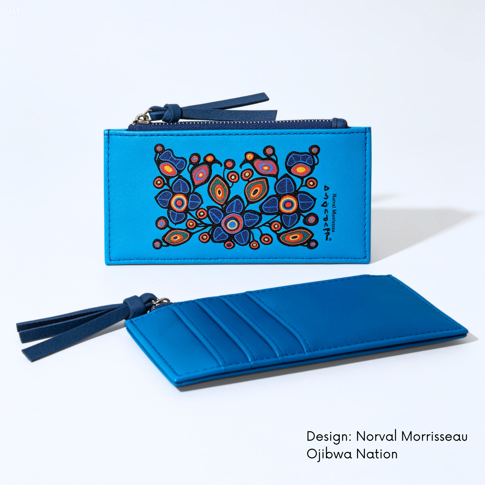 A bright blue leather zip-around wallet shown open and closed on a white background. The closed view shows Norval Morrisseau’s colourful Flowers and Birds artwork, with a dark blue tassel zipper pull.