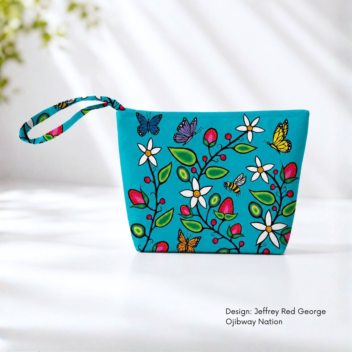 Turquoise canvas pouch covered with flowering branches, berries, green leaves, bees and colourful butterflies.