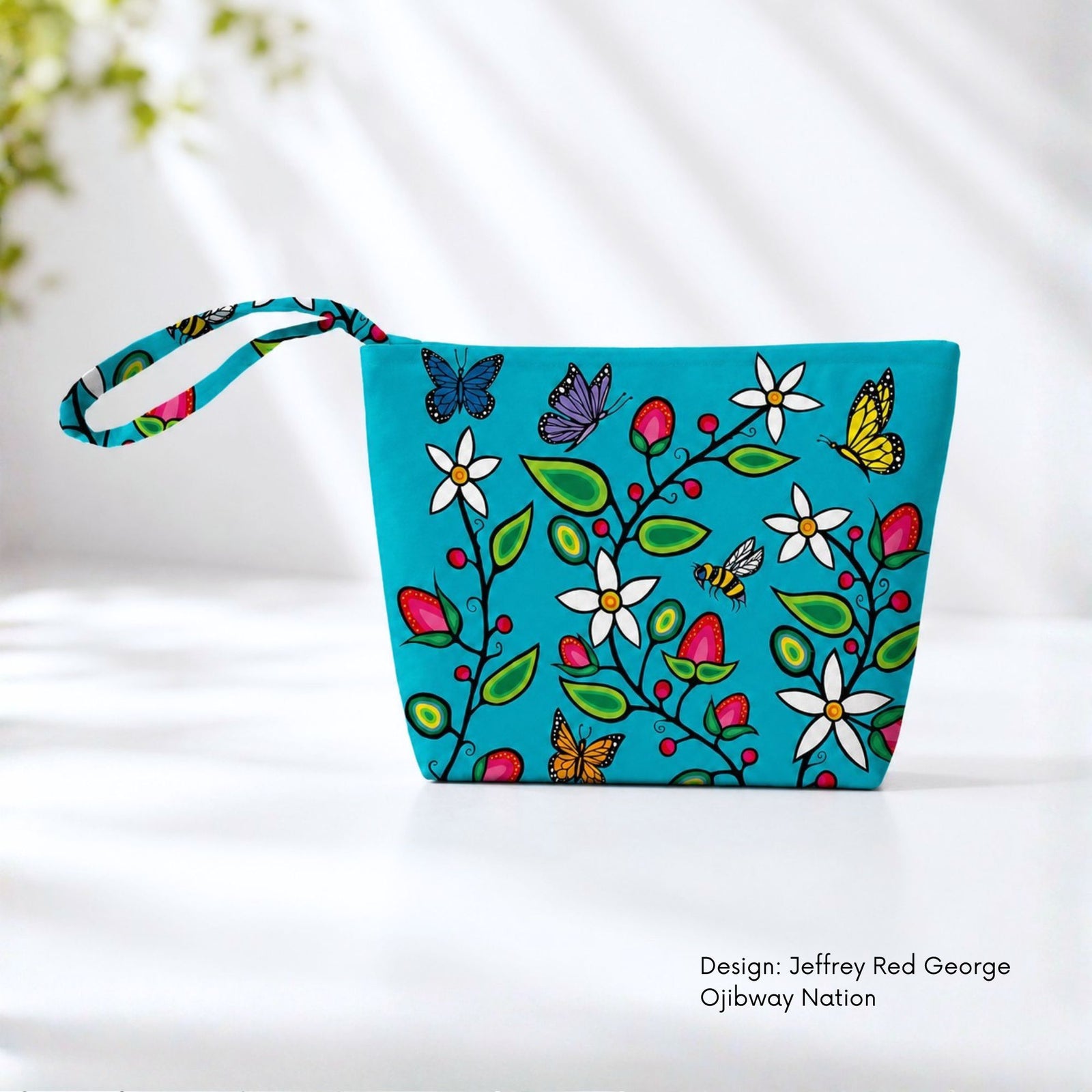 Turquoise canvas pouch covered with flowering branches, berries, green leaves, bees and colourful butterflies.