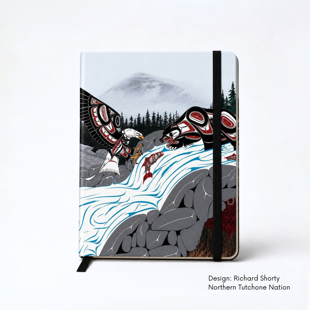 Hardcover journal featuring an eagle and bear fishing for salmon at a rushing waterfall, surrounded by rocks and a dark evergreen forest beneath misty mountains.