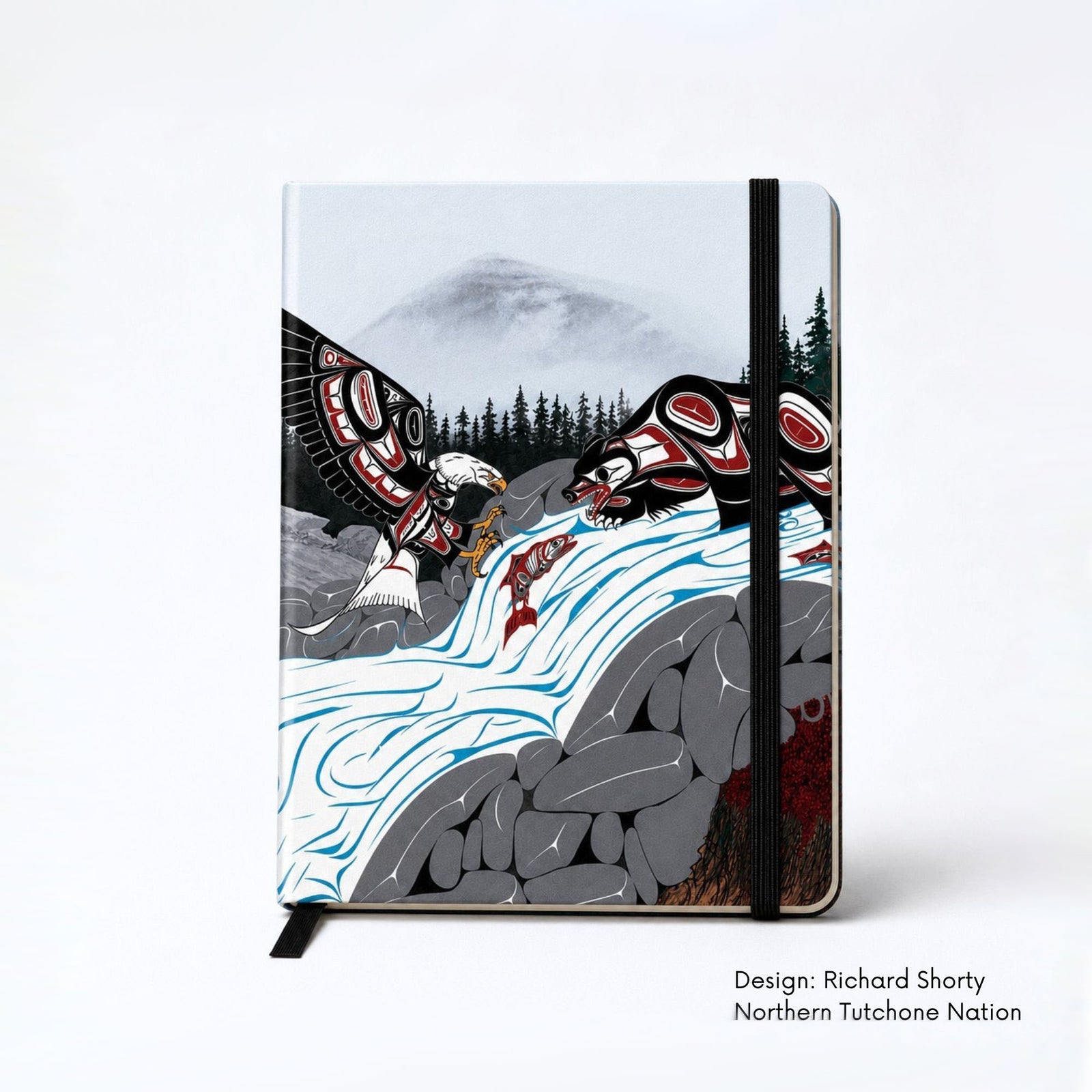 Hardcover journal featuring an eagle and bear fishing for salmon at a rushing waterfall, surrounded by rocks and a dark evergreen forest beneath misty mountains.