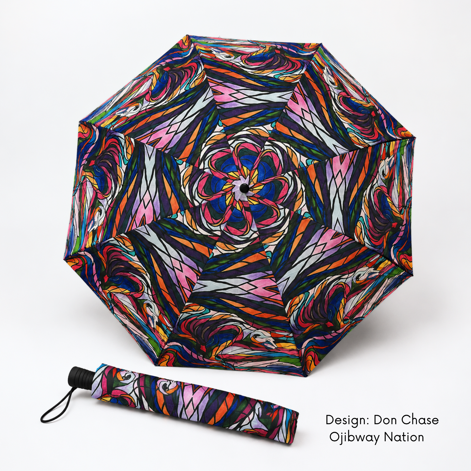 Open folding umbrella and matching sleeve covered in Don Chase’s vivid multicoloured Salmon Hunter artwork.