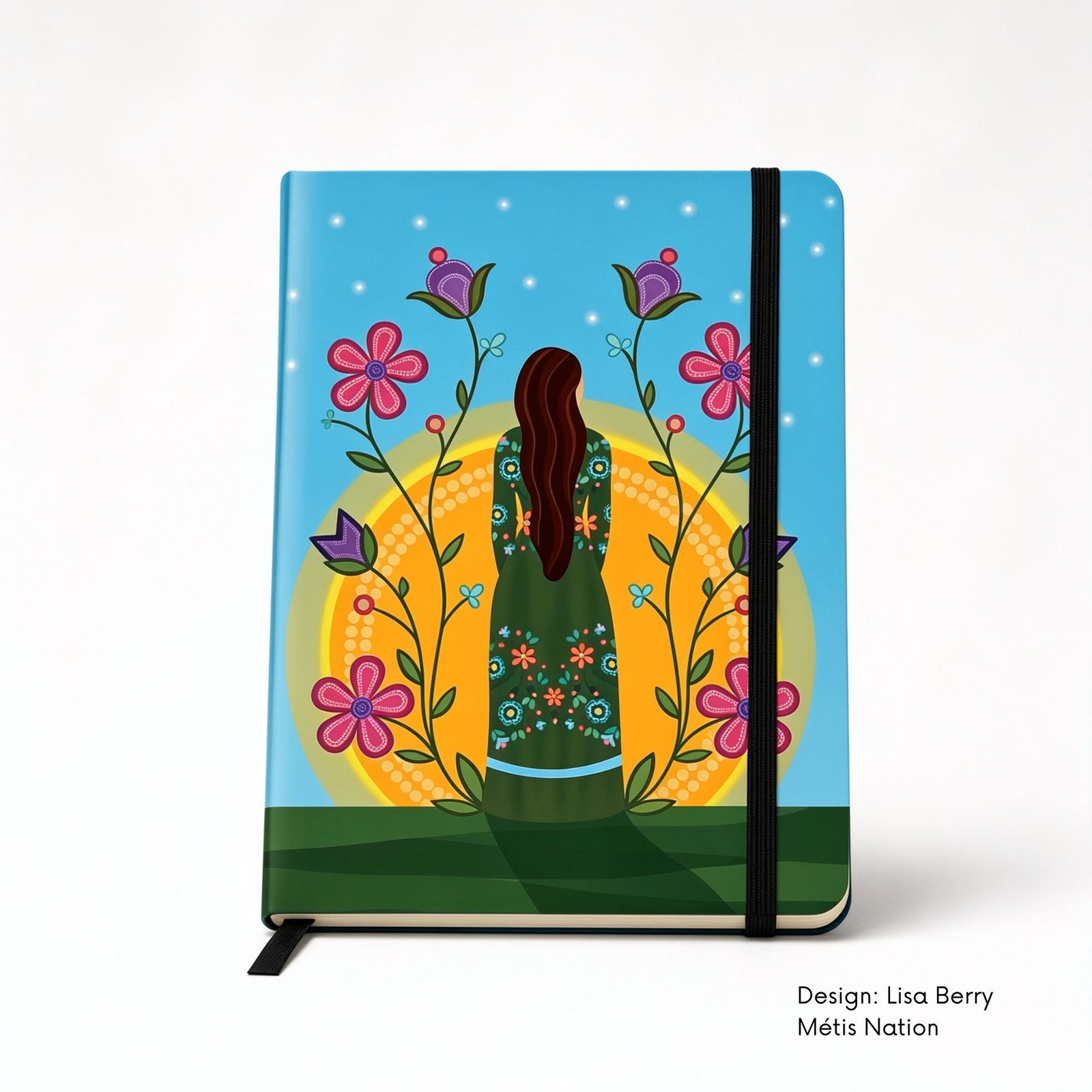 Blue hardcover journal featuring a woman in a green floral dress standing before a glowing sun, surrounded by tall pink and purple flowers.