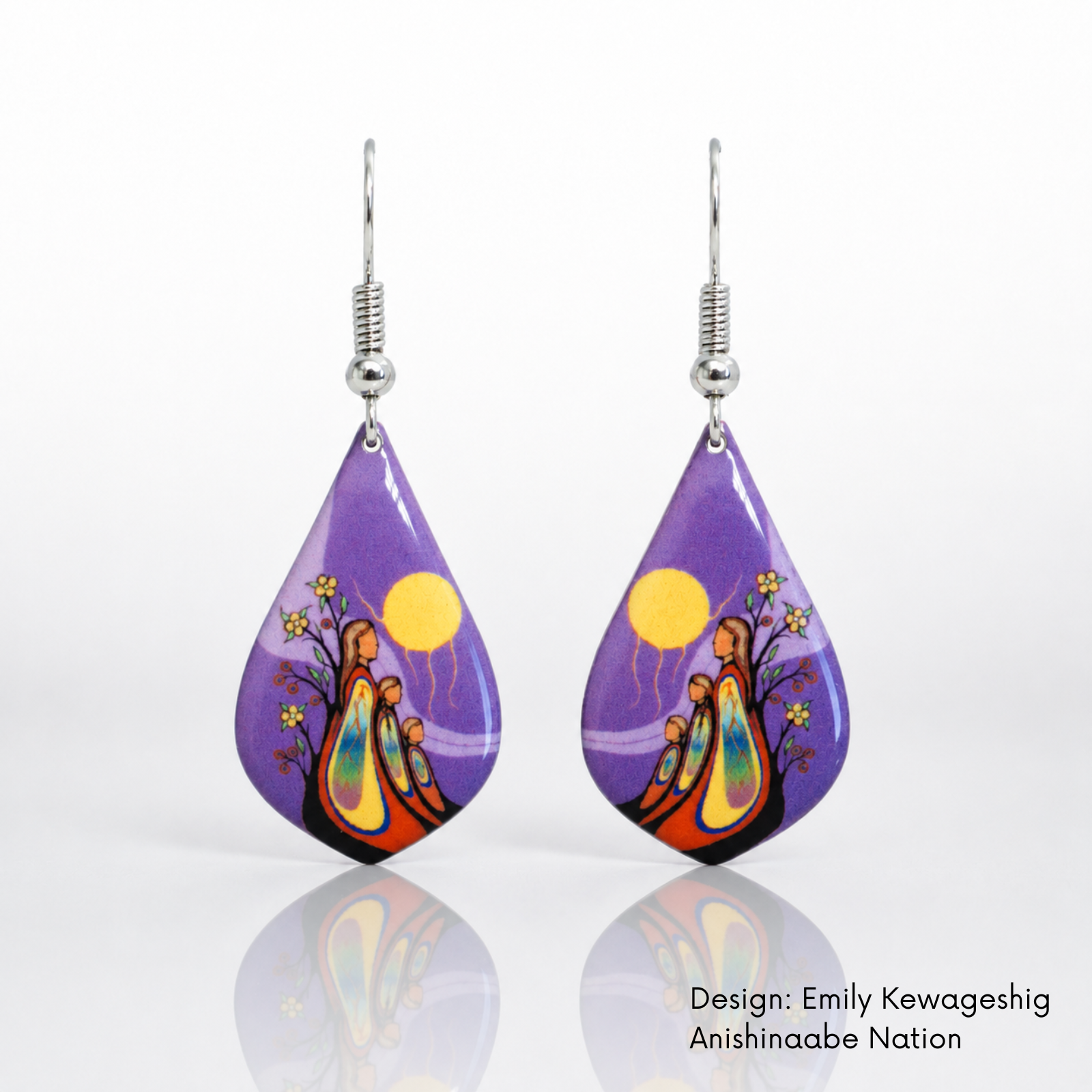  A pair of teardrop-shaped dangling earrings featuring a mother and two children in vivid yellow, orange, blue, pink and green artwork.
The earrings are shown on a white background with a soft reflection below.