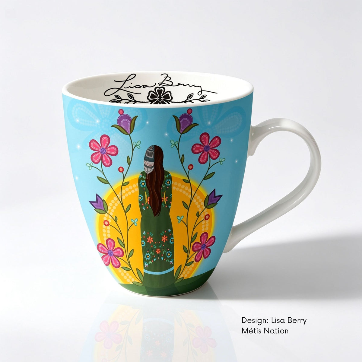 Fine bone china mug featuring Shine On artwork by Métis artist Lisa Berry, showing a woman surrounded by colourful flowers with floral designs on her clothing.