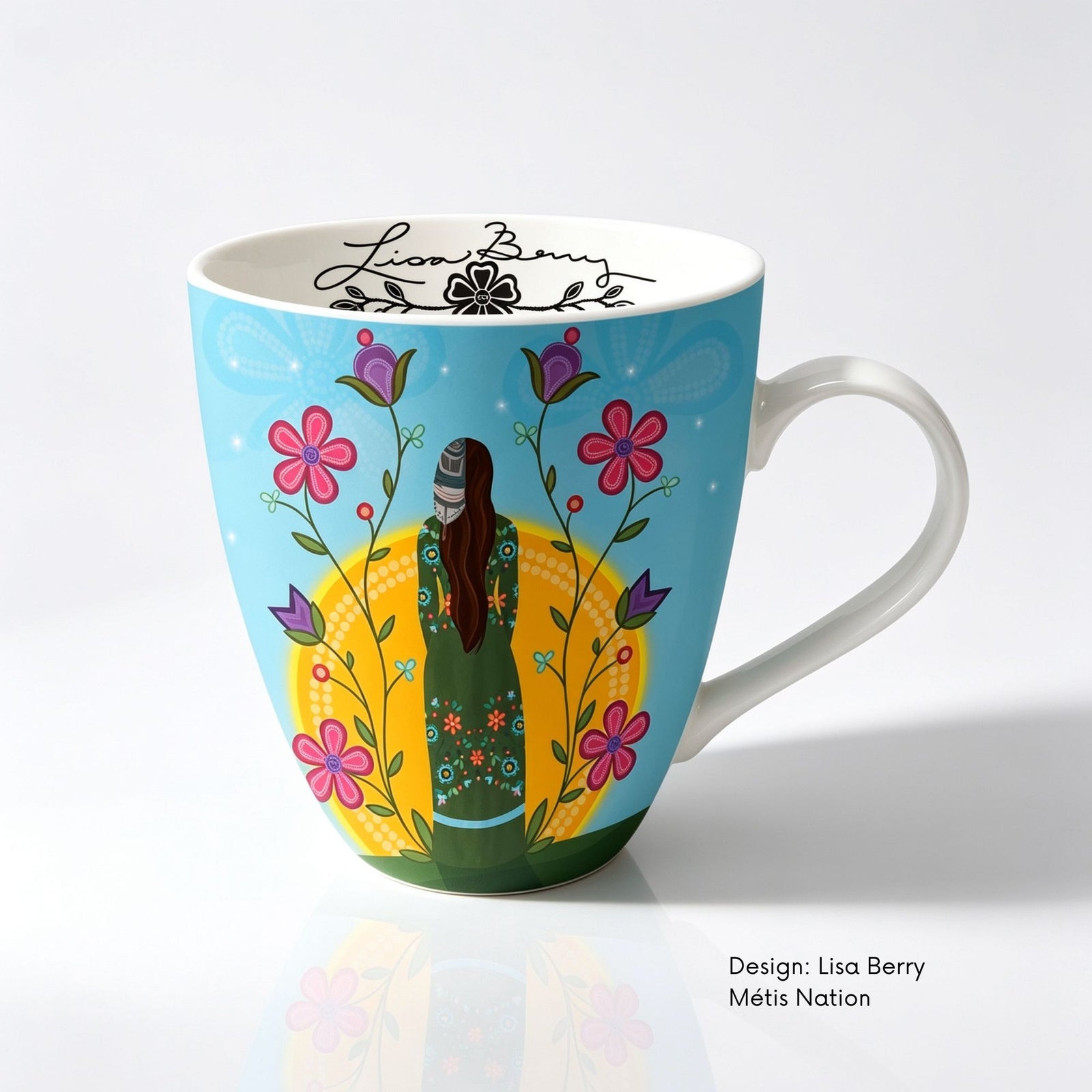 Fine bone china mug featuring Shine On artwork by Métis artist Lisa Berry, showing a woman surrounded by colourful flowers with floral designs on her clothing.